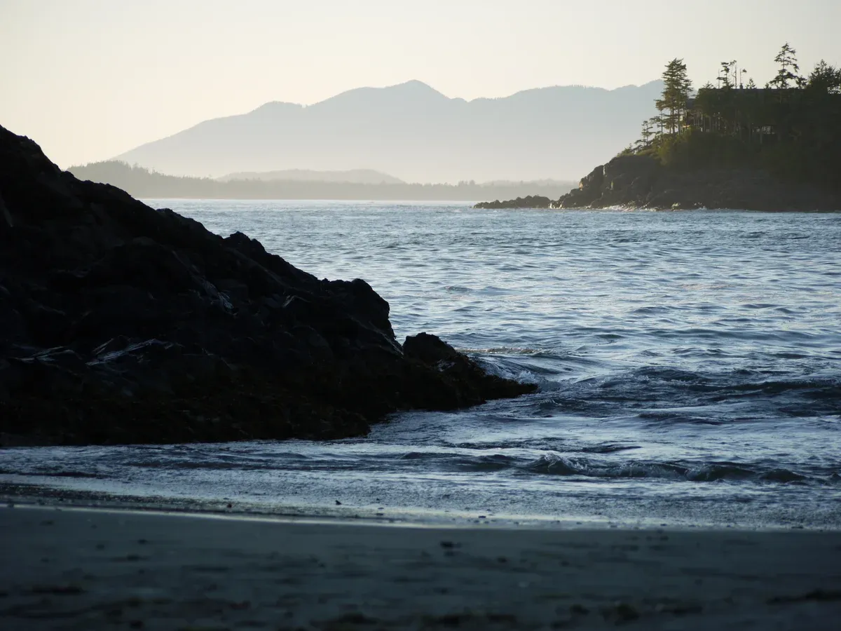 Rocky point and calm water at MacKenzie Beach, one of the free Tofino beaches on the sheltered side of the peninsula
